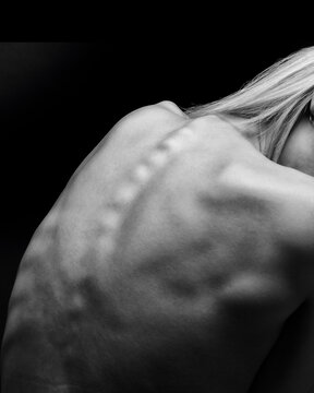Artistic sports conceptual photo of a naked beautiful woman. Beauty nude yoga girl posing on black background.