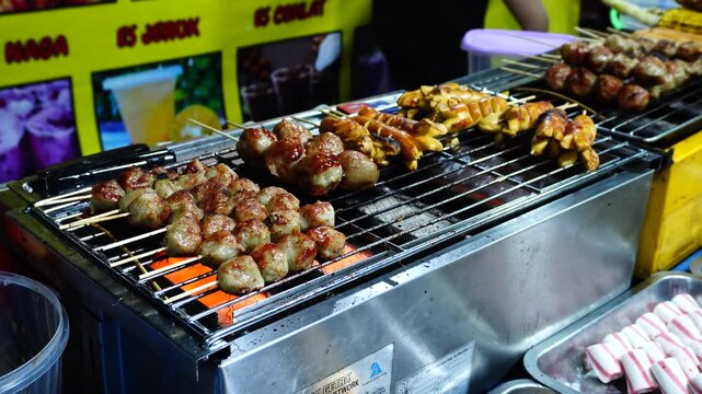 Mixed Food Skewers Grilling at a Street Food Stall
