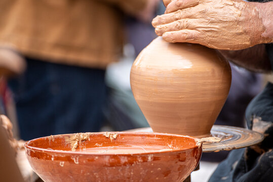 Raigame ethnographic festival potter shaping clay on a wheel The Concept of artistic craft