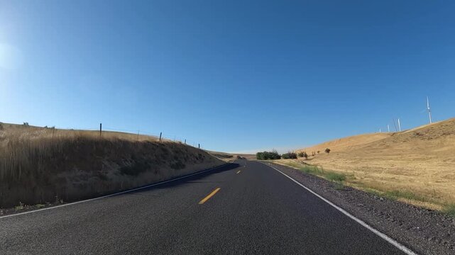 4K action camera footage from a car hood driving countryside roads toward Highway 19 near Arlington, Oregon, USA, through open fields, farms and rural areas of north eastern Oregon