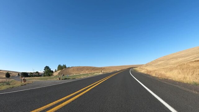 4K action camera footage from a car hood driving countryside roads toward Highway 19 near Arlington, Oregon, USA, through open fields, farms and rural areas of north eastern Oregon