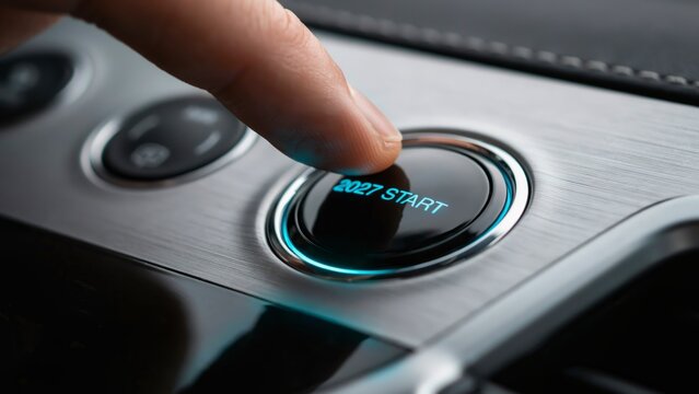 Modern 2027 start button on car dashboard, finger pressing glowing ignition switch, futuristic automotive interior technology