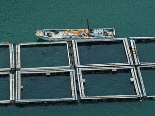 Aerial drone photo of aquaculture fish cages near coastal Taiji, Wakayama, Japan © AeroSkope