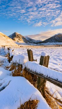 Serene winter valley majestic mountains snowscape golden light peaceful landscape photography tranquil scene