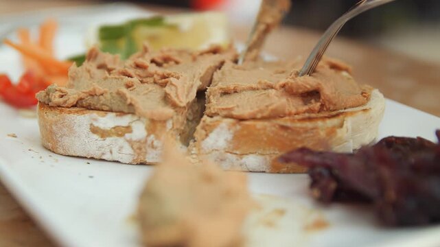 Pate on bread being sliced in half to be consumed close up stock footage