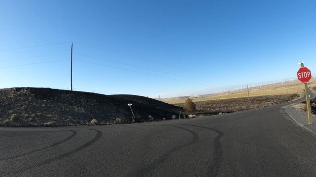 4K action camera footage from a car hood driving countryside roads toward Highway 19 near Arlington, Oregon, USA, through open fields, farms and rural areas of north eastern Oregon