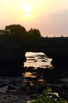 Bali, Indonesia beach rock formation at sunset