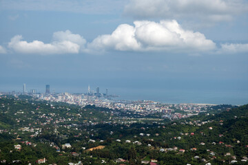 Naklejka premium Batumi Cityscape and Black Sea Coast Panoramic View with Fluffy Cumulus Clouds, Georgia