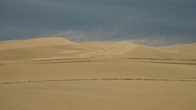 Slow motion view Desert landscape with rolling sand dunes and dramatic sky in motion