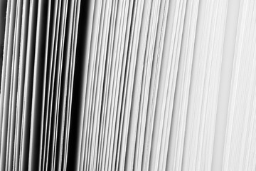 Fototapeta premium Abstract Close-up of White Book Pages and Vertical Lines Pattern,Macro,A high-contrast black and white abstract macro photograph showing the intricate geometric pattern of stacked white paper sheets, 