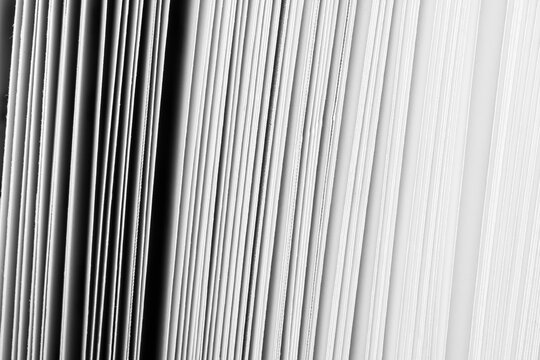 Abstract Close-up of White Book Pages and Vertical Lines Pattern,Macro,A high-contrast black and white abstract macro photograph showing the intricate geometric pattern of stacked white paper sheets, 