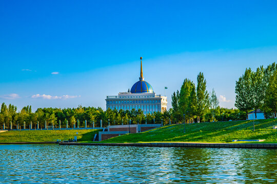 Astana, Kazakhstan, 05.08.2026: Akorda Presidential Palace with green park and calm river