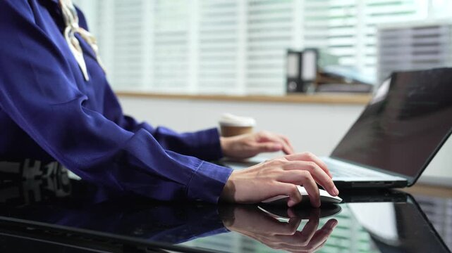 Asian woman digital nomad managing online business and financial budget at desk.
