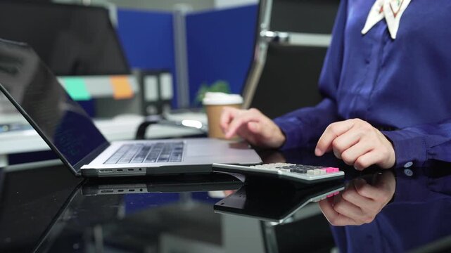Hand women doing finances and calculate on desk about cost at  office.