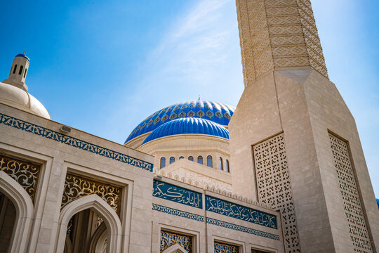 Low angle view of ornate Nursultan mosque entrance portal with blue tile mosaic decoration in Astana