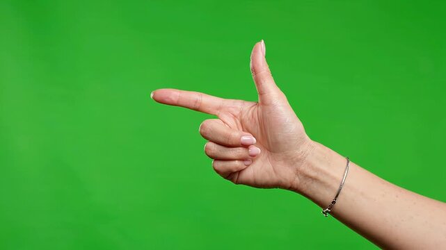 Woman hand pointing finger gun gesture isolated on green screen keying background