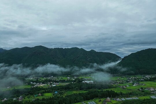 Aerial drone photo of sea of clouds over mountain village in Mihama-cho, Mie, Japan