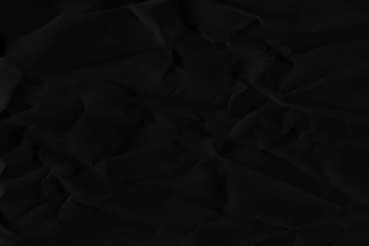 Silhouette of the number 44 formed by creases on a dark black crumpled paper texture forty-four digit