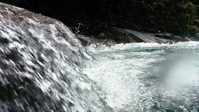 Small Waterfall Pouring Into Clear Pool in Ecuador Rainforest River, Whitewater Splash, Dark Rocks and Tropical Freshwater Nature Scene