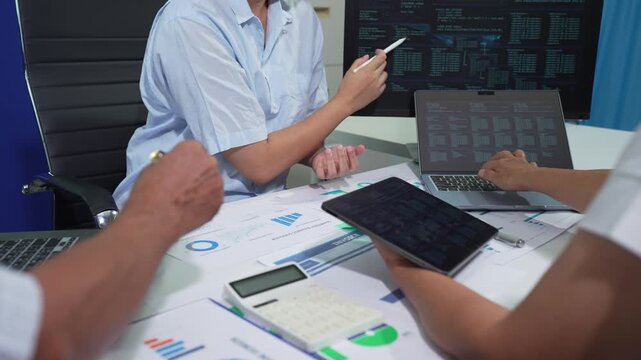 Businessmen team or financial data analysts working with tablets and laptop computers and data graphs together. Plan to analyzing projects in the office.