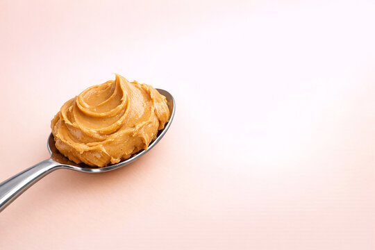 Peanut butter in a spoon, ready to be enjoyed.