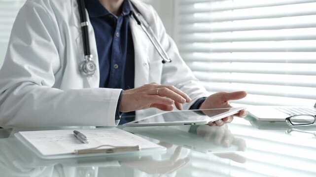 Doctor taking notes on a clipboard and holding a digital tablet, combining traditional paperwork with modern technology in healthcare for patient record management and medical consultation