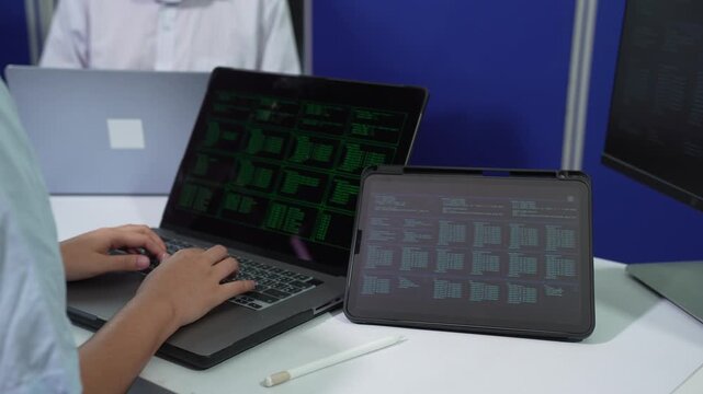 Male coder or developer working overtime using a computer display in problem solving at workplace.