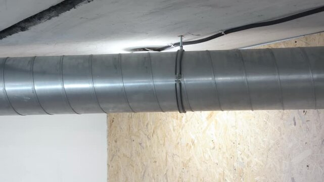 A metal air duct connects to a round channel with an elbow