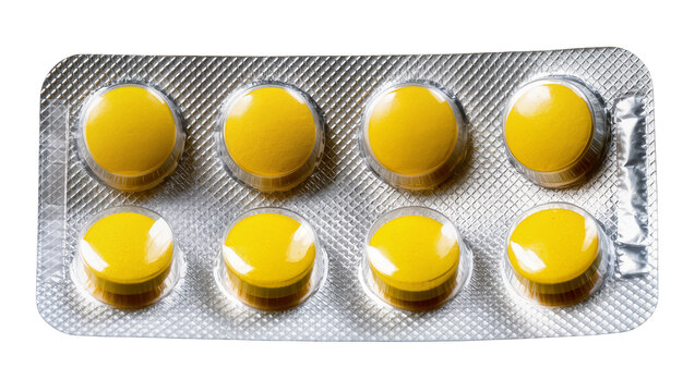 Isolated yellow round pills in silver pharmaceutical blister pack for health treatment.