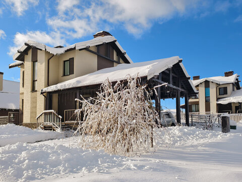 Snow-covered country garden in a siberian cottage village.