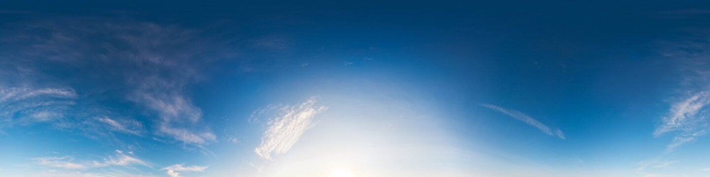 Sky panorama atmosphere clouds seamless 360 degree equirectangular view with bright sun glow and wispy clouds for VR design