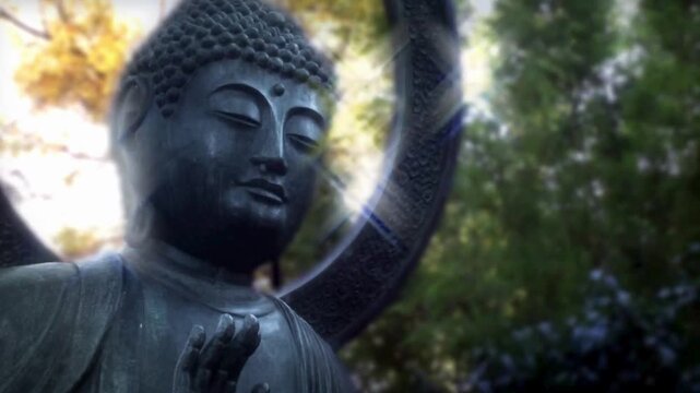 Stone buddha statue with soft sunlight glowing in peaceful garden setting cinematic footage.