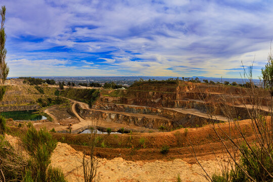 Large quarry landscape in Churchill National Park with distant view of Melbourne CBD skylin