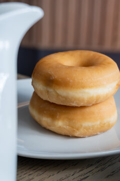 Stacked glazed donuts on a plate