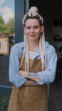 Woman potter welcomes visitors near open ceramic studio entrance