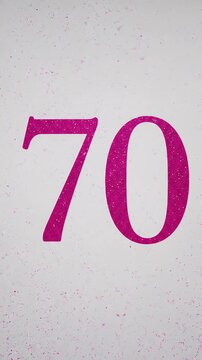 Pink Glitter Blows Away and Reveals the Number 70 on Solid Background