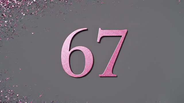 Pink Glitter Blows Away and Reveals the Number 67 on Solid Background