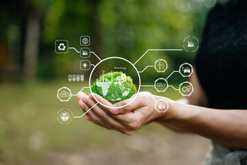 Obraz premium Hand holding a mossy earth globe with carbon neutral and green energy HUD icons for environmental conservation