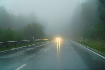 Fototapeta premium A wet asphalt road in autumn, in the rain.