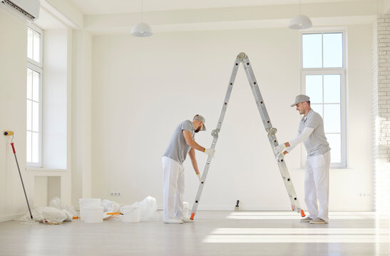 Painters team or construction workers planning repair, ladder fixing to protect during wall color renovation after moving into new apartment, interior design home plan, new house remodeling ideas