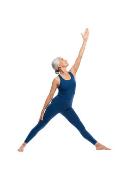 Active senior woman with gray hair doing triangle yoga pose in blue sportswear, isolated on transparent background