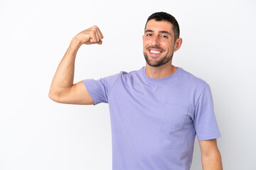 Fototapeta premium Young handsome caucasian man isolated on white background doing strong gesture