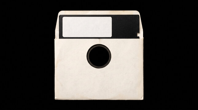 Vintage white floppy disk inside paper sleeve isolated on black background representing retro technology with partially inserted paper information computer obsolete