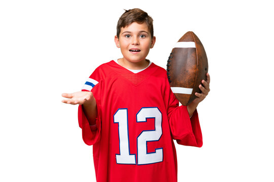 Little caucasian kid playing rugby over isolated chroma key background with shocked facial expression
