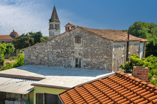 Historic stone house rooftops and church bell tower. Tar, Croatia.
