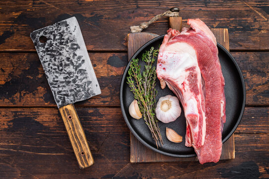 Raw beef bone with thick meat attached, butcher style cut ideal for roasting, braising or slow cooking rich and hearty dishes.