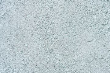 Abstract blue stucco wall texture background with a subtle rough finish and copy space. © Saminda