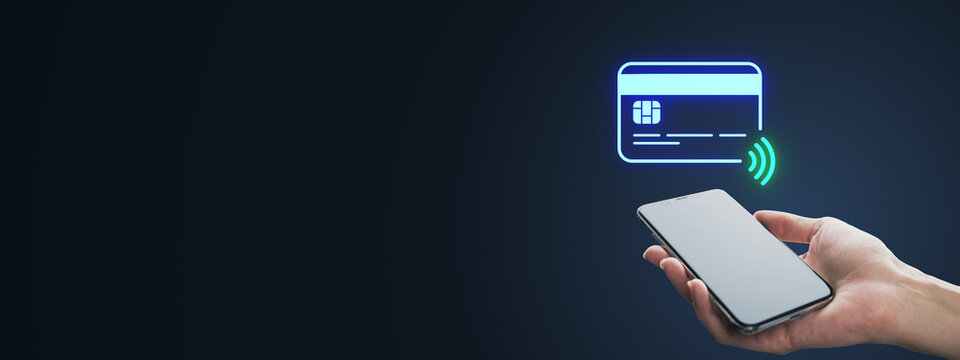 Contactless mobile payment with smartphone and glowing NFC card icon on dark background, featuring generous copy space for creative finance design concepts.