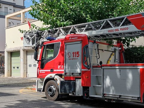 Ostia, Rome, Italy - August 5, 2026, perspective view of the historic building, with the red sign, which houses the Fire Brigade Station, with an operational vehicle ready to intervene.