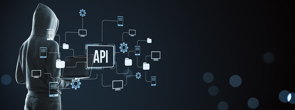 Hooded cybersecurity specialist using laptop with API network connections, digital technology icons, modern dark background and copy space for design.